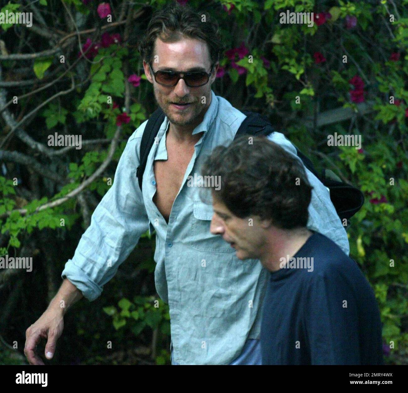 Exclusive!! Matthew McConaughey enjoys the Florida heat poolside with a friend. The Sahara star had just flown in from Canada. Miami Beach, 3/31/05 Stock Photo