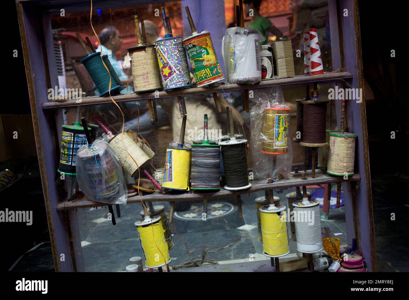Rolls of kite strings are displayed for sale in the old quarters of New