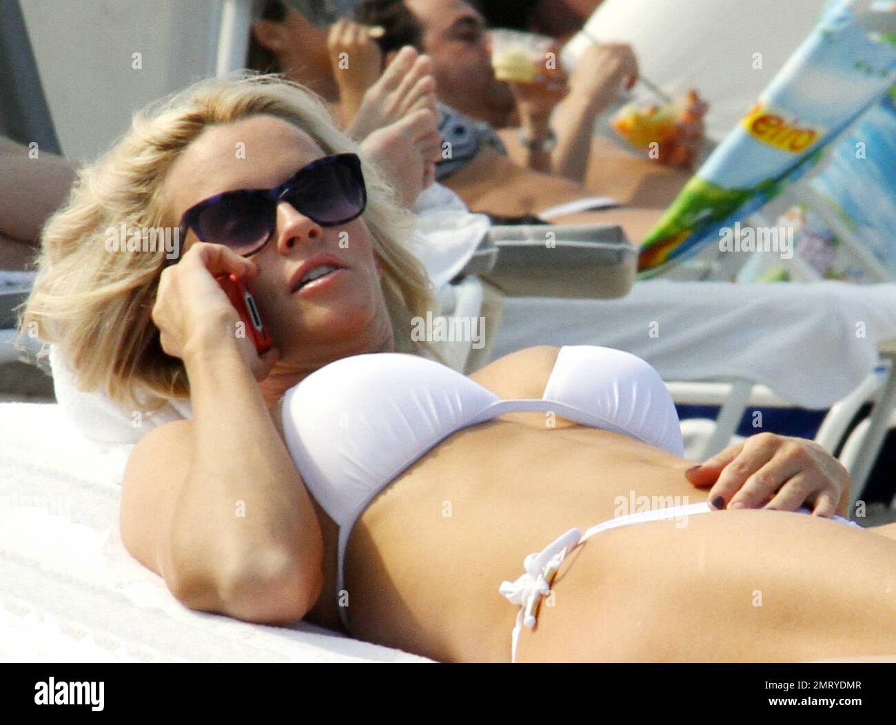 EXCLUSIVE!! Jenny McCarthy and her sister JoJo McCarthy spend some sibling  bonding time on the beach in Bikinis. Jenny showed off her incredible  figure in an all white bikini as she lounged