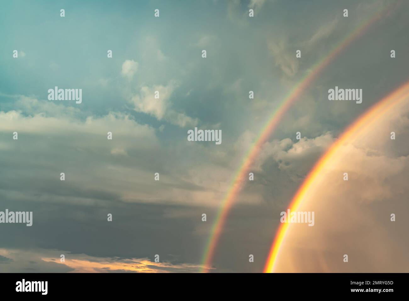 Double rainbow in the clouds during the day after the rain Stock Photo ...