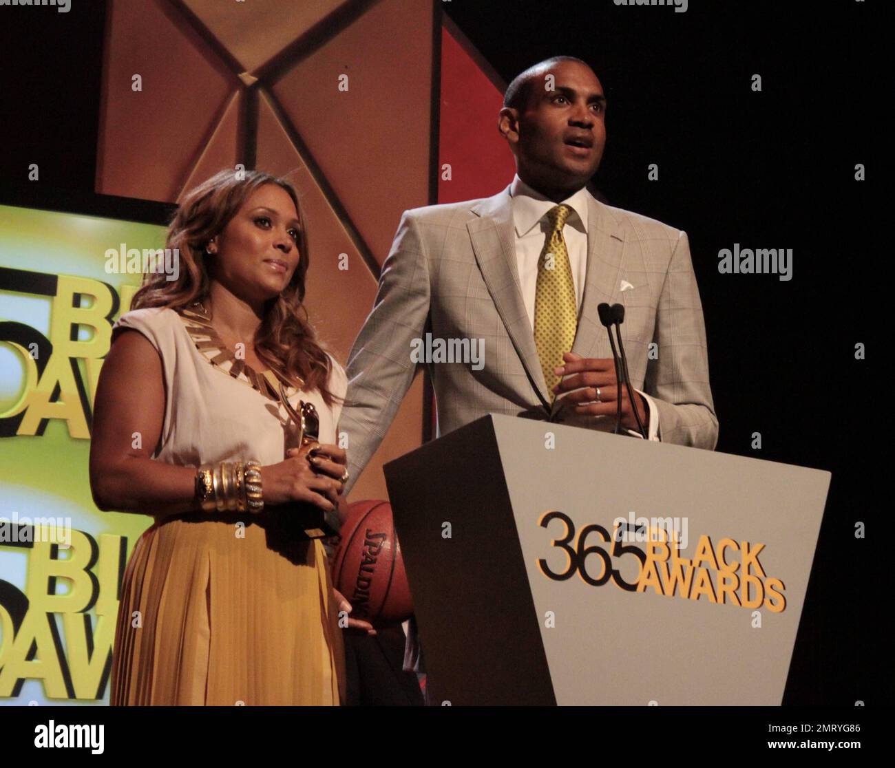 R&B singer Tamia and husband Grant Hill of the Phoenix Suns give their acceptance speech while being honored during the McDonald's 365 Black Awards held at the Mahalia Jackson Theatre in New Orleans, Louisiana. 6th July 2012. Stock Photo