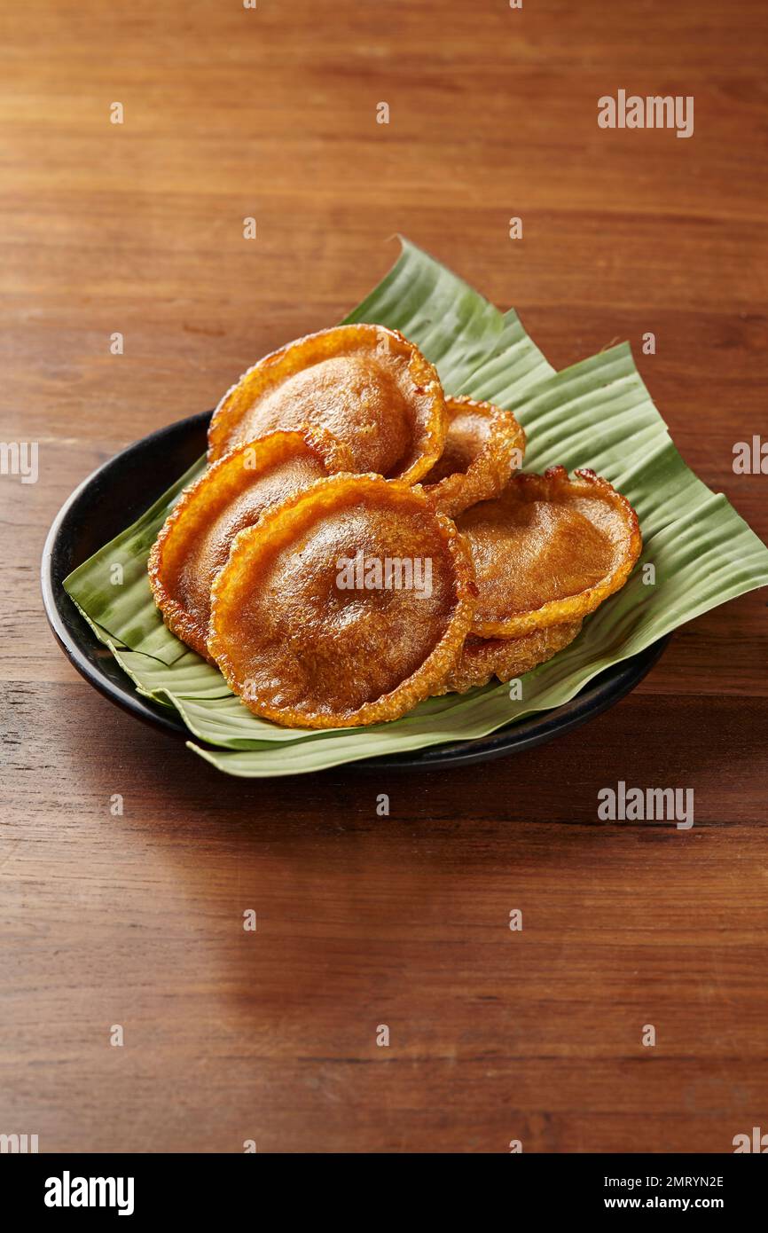 Kue Cucur, the name of a traditional cake from Jakarta, Indonesia. Served on a plate lined with banana leaves Stock Photo