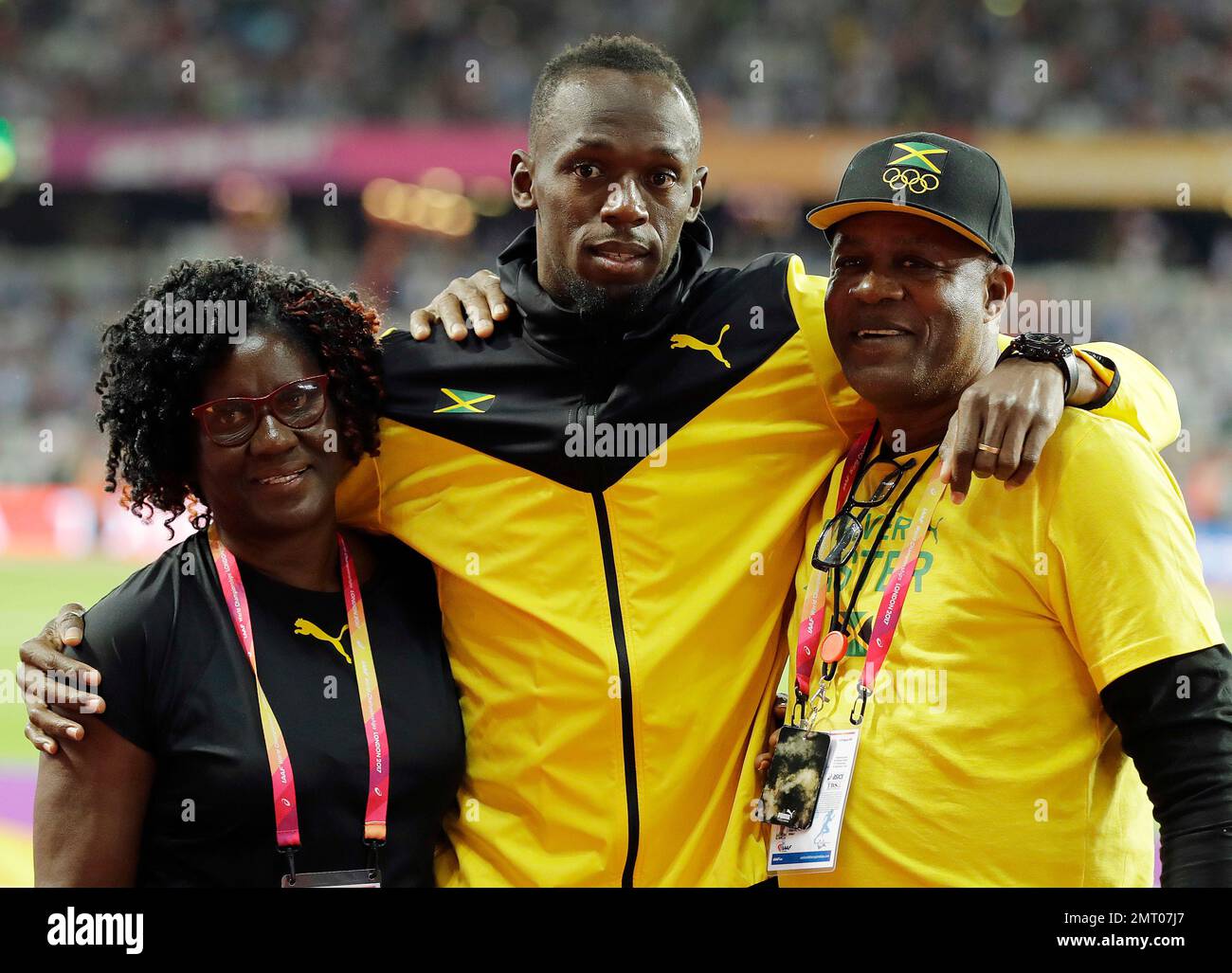 Jamaica's Usain Bolt meets his parents during a goodbye lap during the