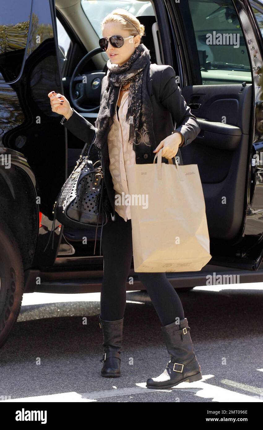 EXCLUSIVE!! Mena Suvari, star of the 'American Pie' flicks and Oscar winning film 'American Beauty' was seen arriving at the 'Chelsea Lately! Show' wearing a black jacket, tan top, black leggings, a patterned scarf, black boots and accessorized with dark shades and a large black purse. The 33 year old actress is currently promoting the latest installment of the American Pies, 'American Reunion.' Los Angeles, CA. 20th March 2012. Stock Photo