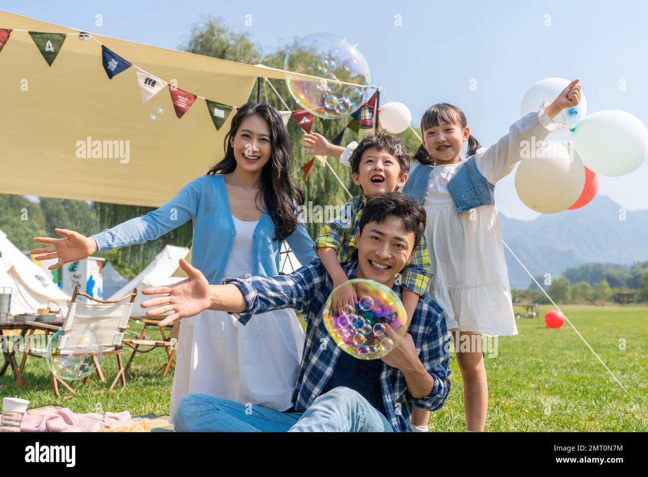 Two girls smiling play picnic hi-res stock photography and images - Alamy