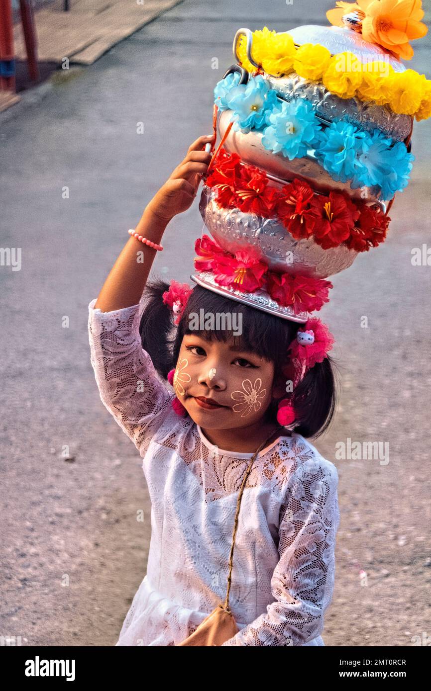 Mon girl in traditional dress during the morning alms ceremnoy in Sangkhlaburi, Thailand Stock Photo