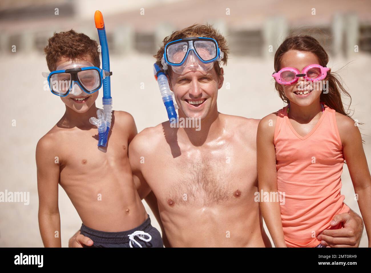 Family snorkeling adventures. Portrait of a family wearing snorkeling gear at the beach Stock