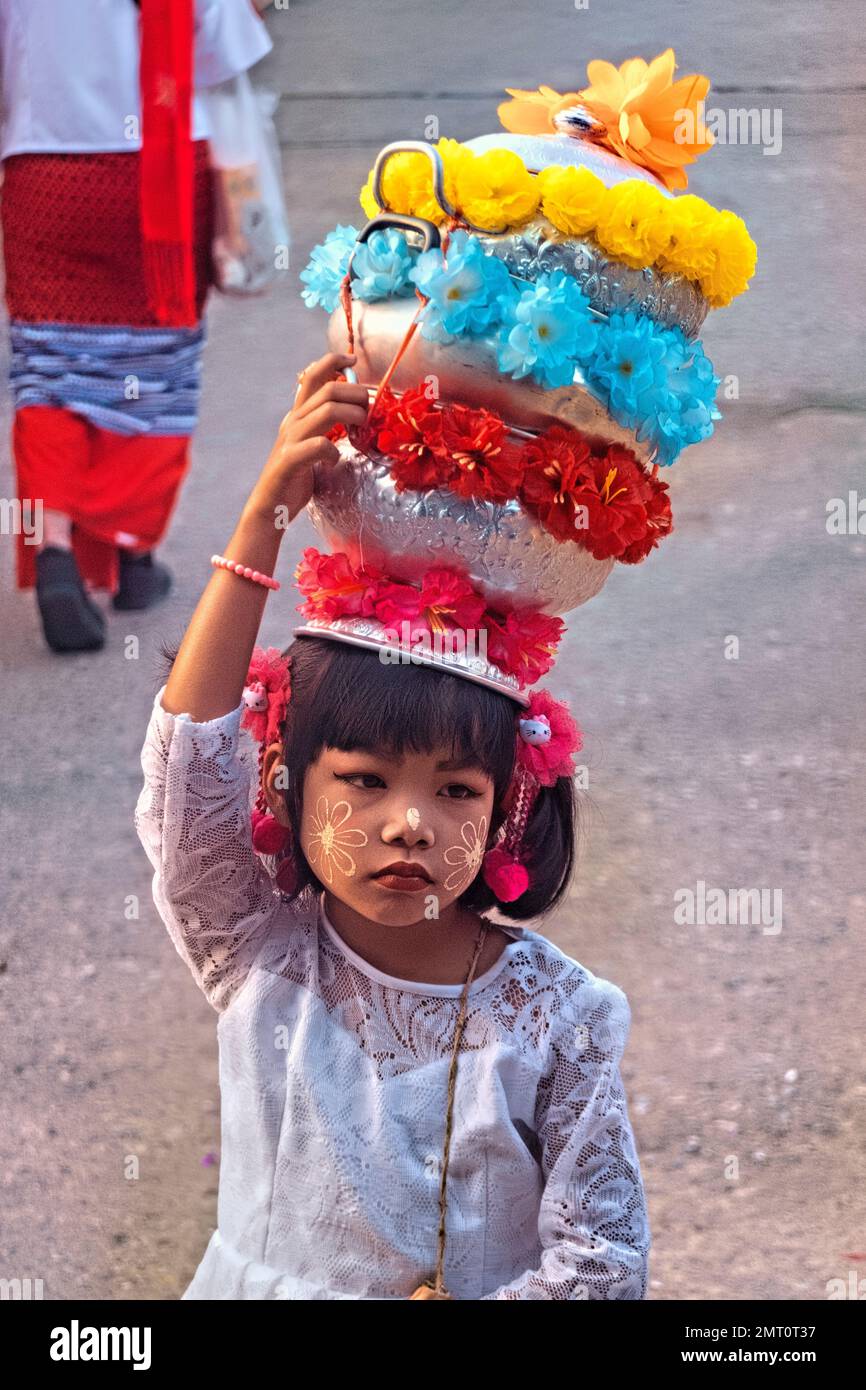 Mon girl in traditional dress during the morning alms ceremnoy in Sangkhlaburi, Thailand Stock Photo