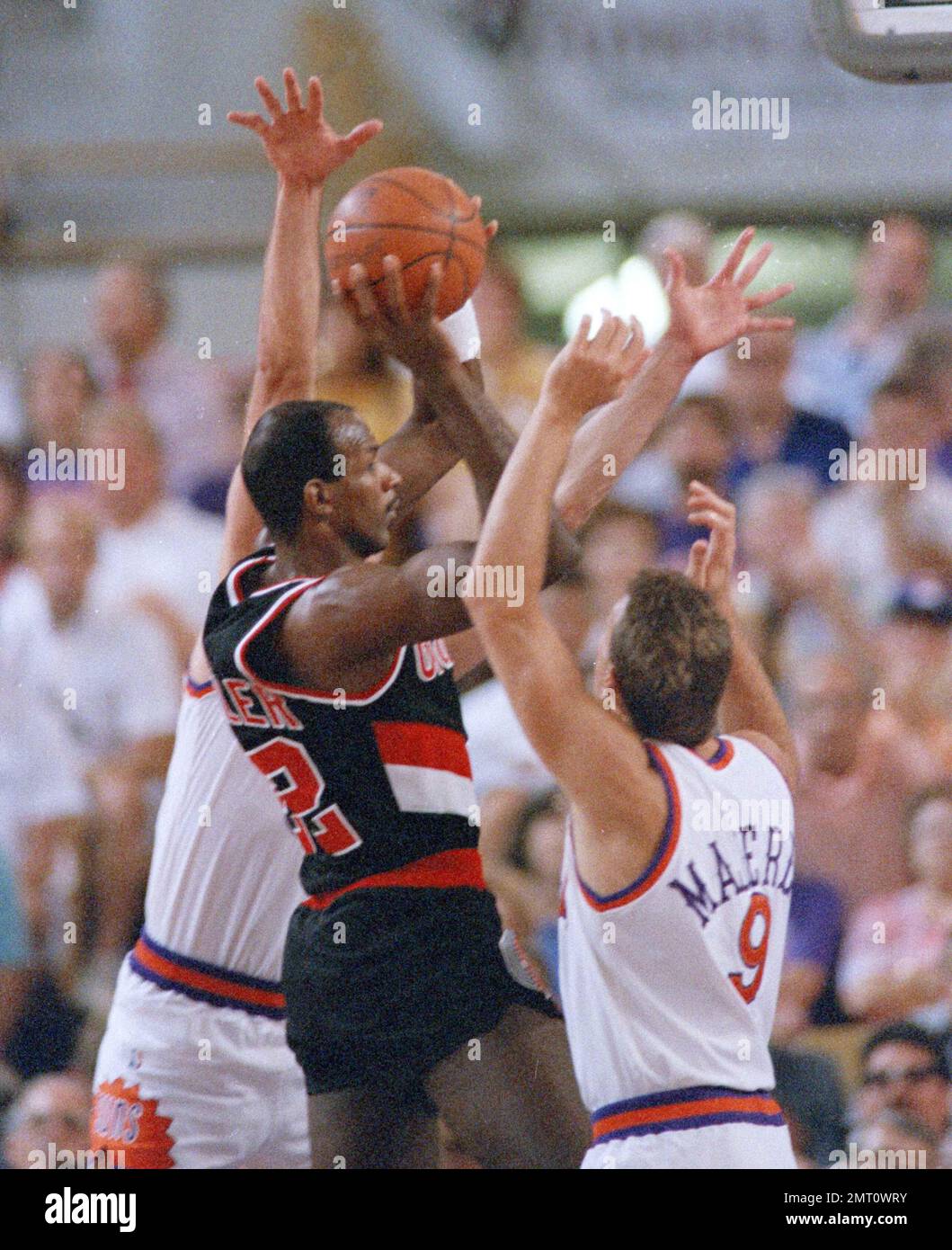 Portland's Clyde Drexler takes the ball to the basket as Suns' Dan ...