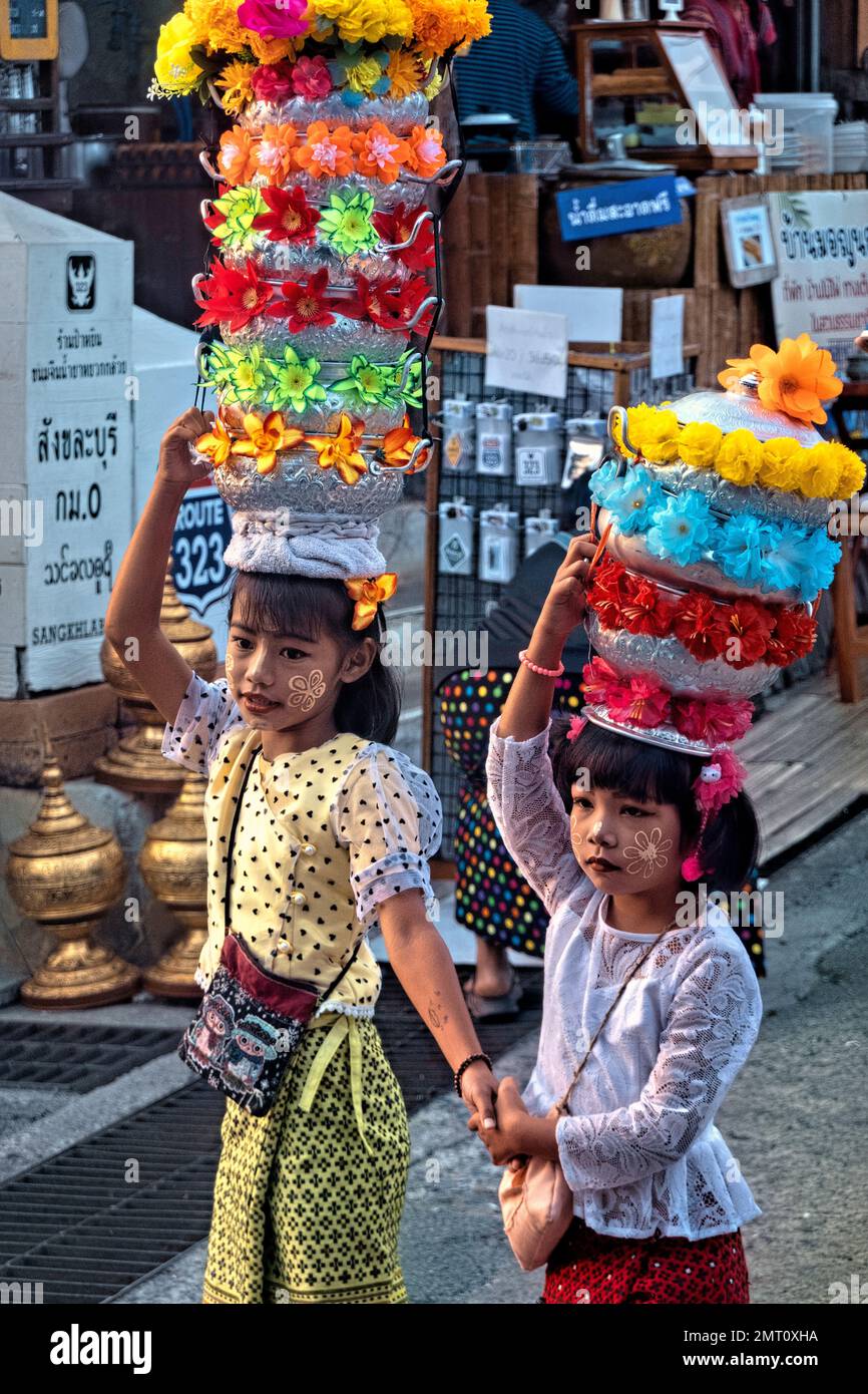 Mon girls in traditional dress during the morning alms ceremnoy in Sangkhlaburi, Thailand Stock Photo