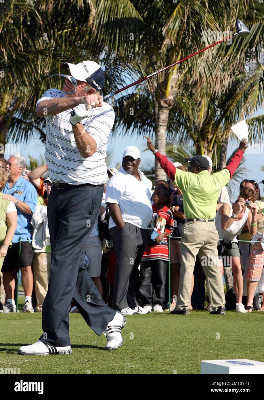 Exclusive!! James Caan's sunglasses fly off as he plays on day three of The Michael Jordan Celebrity Invitational golf tournament held at the luxurious One and Only Ocean Club Golf Course on Paradise Island. At one point, Young hit one into the rough which, in this case, was the beach on the other side of a wall! He worked very hard to get it back onto the course. At least it didn't end up in the ocean. The MJCI organization brings in an incredible array of talent from the worlds of sport and entertainment to compete on the course and participate in various events for charity in this annual ev Stock Photo