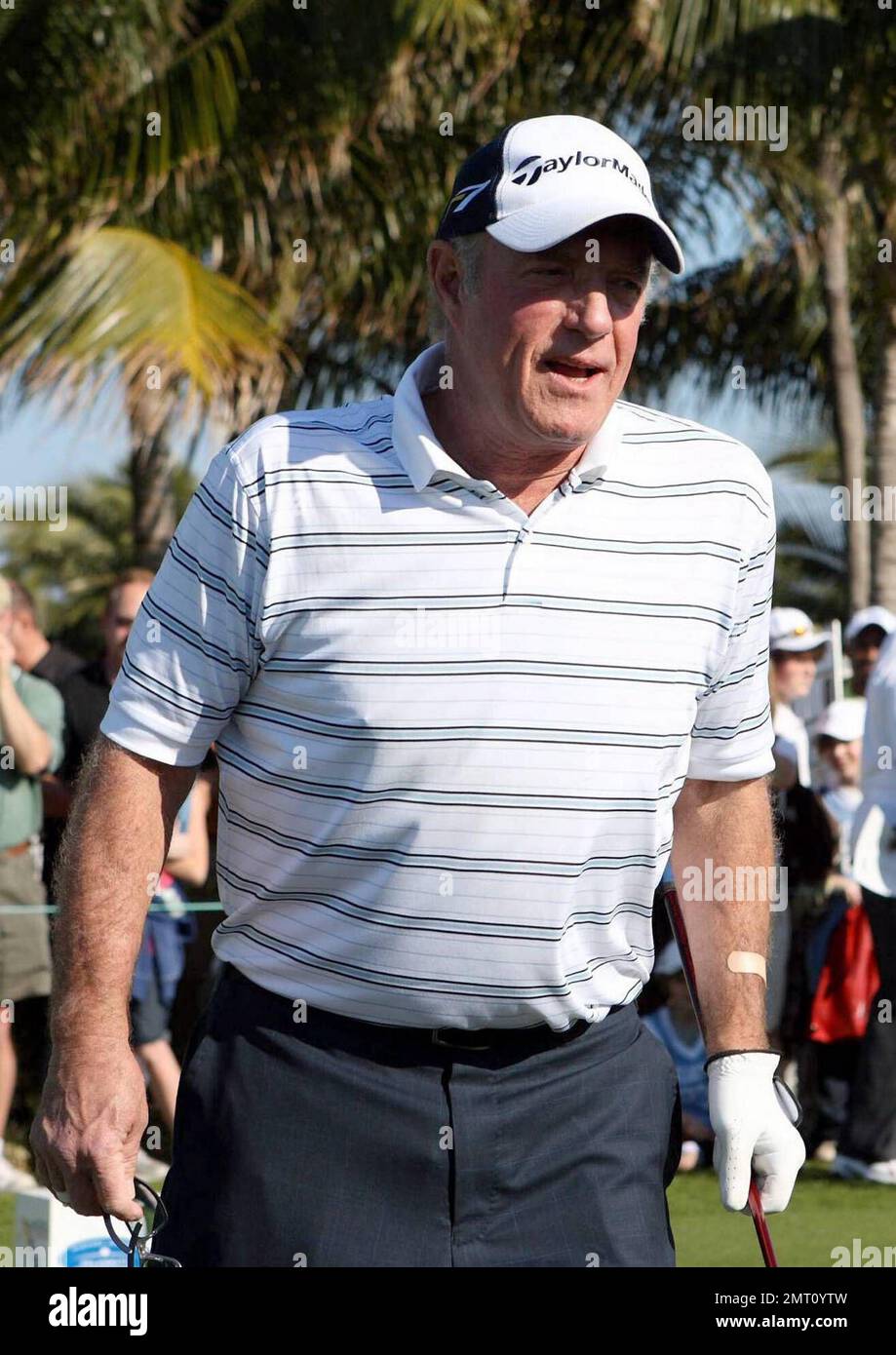 Exclusive!! James Caan plays on day three of The Michael Jordan Celebrity Invitational golf tournament held at the luxurious One and Only Ocean Club Golf Course on Paradise Island. At one point, Young hit one into the rough which, in this case, was the beach on the other side of a wall! He worked very hard to get it back onto the course. At least it didn't end up in the ocean. The MJCI organization brings in an incredible array of talent from the worlds of sport and entertainment to compete on the course and participate in various events for charity in this annual event.  In it's seventh year Stock Photo