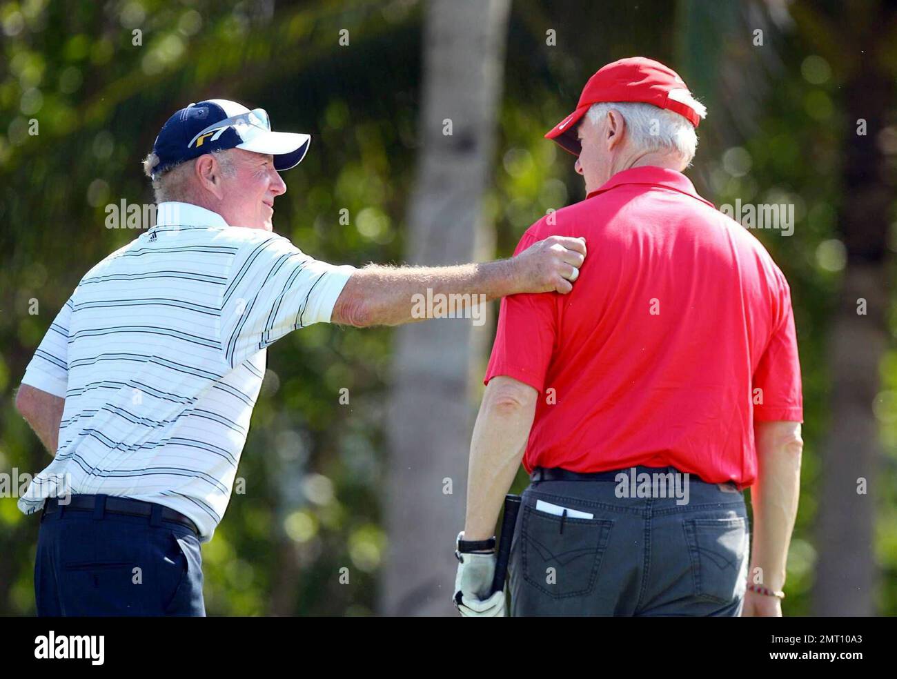Exclusive!! James Caan and President Bill Clinton play on day three of The Michael Jordan Celebrity Invitational golf tournament held at the luxurious One and Only Ocean Club Golf Course on Paradise Island. At one point, Young hit one into the rough which, in this case, was the beach on the other side of a wall! He worked very hard to get it back onto the course. At least it didn't end up in the ocean. The MJCI organization brings in an incredible array of talent from the worlds of sport and entertainment to compete on the course and participate in various events for charity in this annual eve Stock Photo