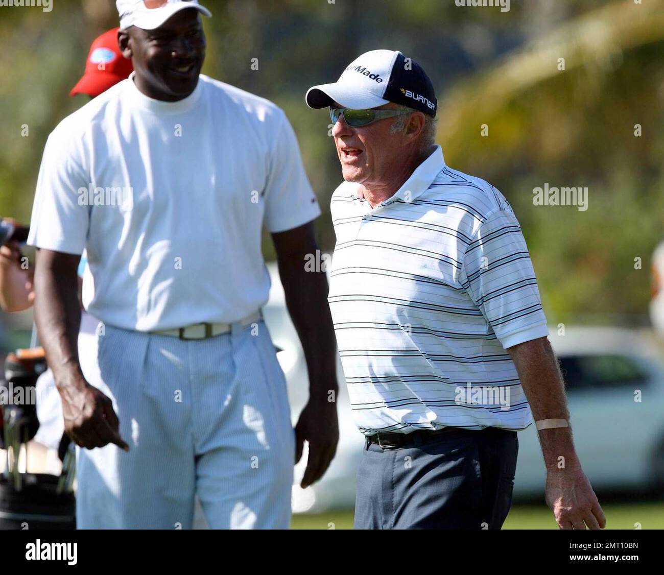 Exclusive!! James Caan and Michael Jordan play on day three of The Michael Jordan Celebrity Invitational golf tournament held at the luxurious One and Only Ocean Club Golf Course on Paradise Island. At one point, Young hit one into the rough which, in this case, was the beach on the other side of a wall! He worked very hard to get it back onto the course. At least it didn't end up in the ocean. The MJCI organization brings in an incredible array of talent from the worlds of sport and entertainment to compete on the course and participate in various events for charity in this annual event.  In Stock Photo