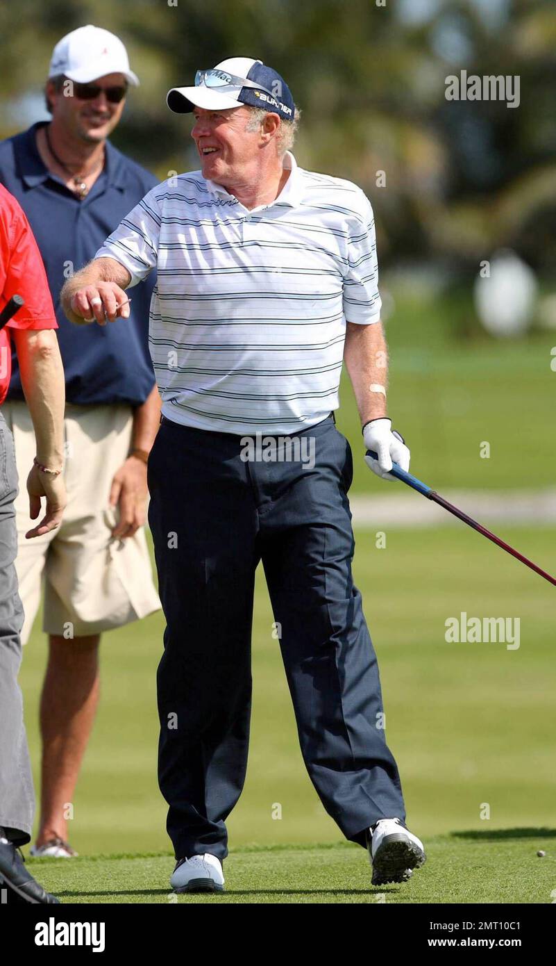 Exclusive!! James Caan plays on day three of The Michael Jordan Celebrity Invitational golf tournament held at the luxurious One and Only Ocean Club Golf Course on Paradise Island. At one point, Young hit one into the rough which, in this case, was the beach on the other side of a wall! He worked very hard to get it back onto the course. At least it didn't end up in the ocean. The MJCI organization brings in an incredible array of talent from the worlds of sport and entertainment to compete on the course and participate in various events for charity in this annual event.  In it's seventh year Stock Photo