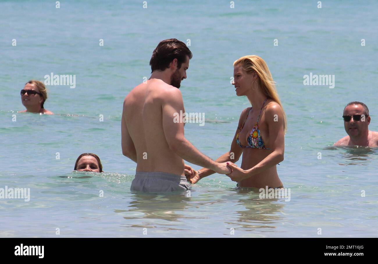 Swiss TV host and actress Michelle Hunziker spends the day in Miami Beach with boyfriend Tomaso Trussardi. 35 year old Hunziker wore a multi-color string bikini that showed off her amazing toned figure. The couple were seen taking a dip in the ocean, sharing a kiss and happily walking hand-in-hand. Miami Beach, FL. 3rd June 2012. Stock Photo