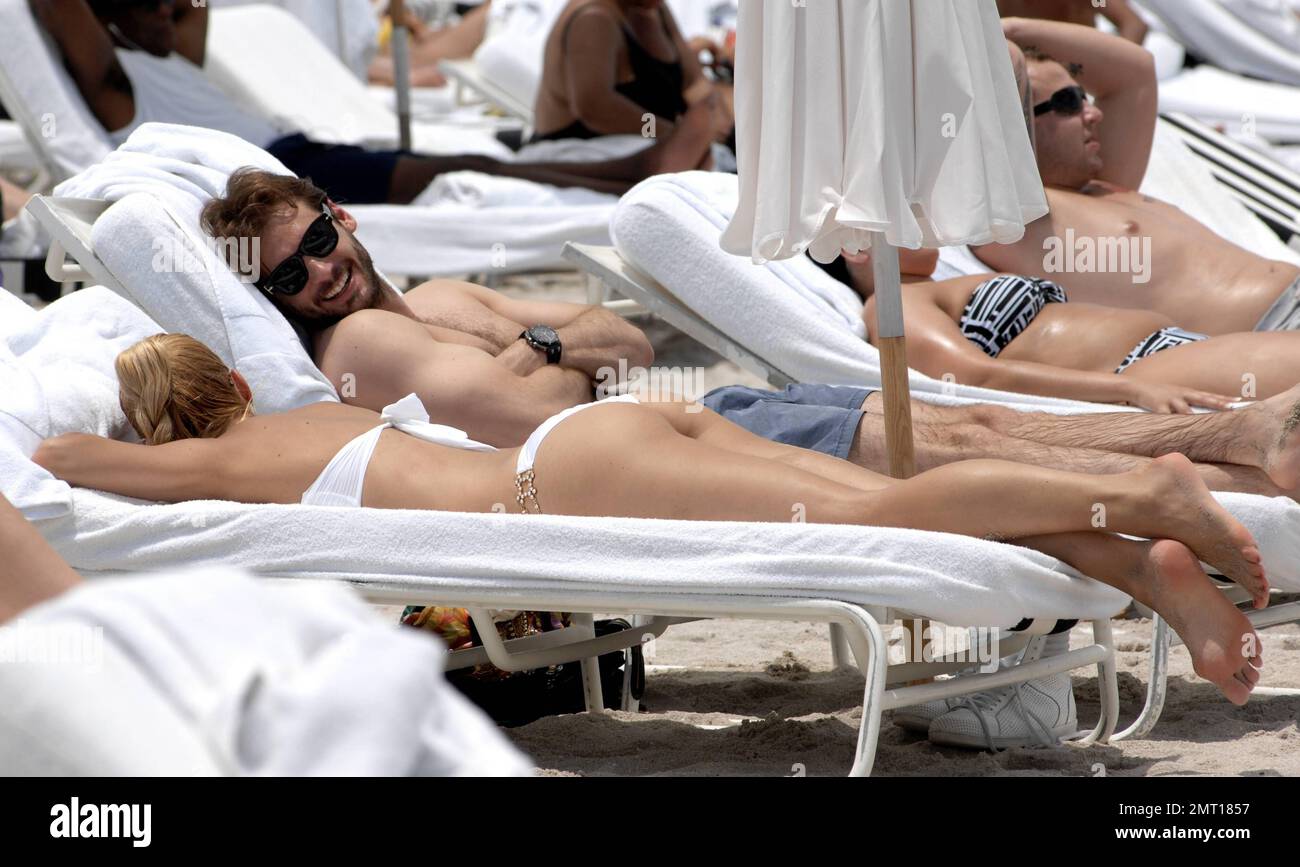 Swiss TV host and actress Michelle Hunziker was seen showing off her amazing figure in a white bikini whilst spending the day at the beach with boyfriend Tomaso Trussardi. 35 year old Hunziker was seen walking hand in hand with Trussardi as they cooled off in the ocean. The couple were later seen sharing a kiss as the left the beach. Miami Beach, FL. 2nd June 2012. Stock Photo