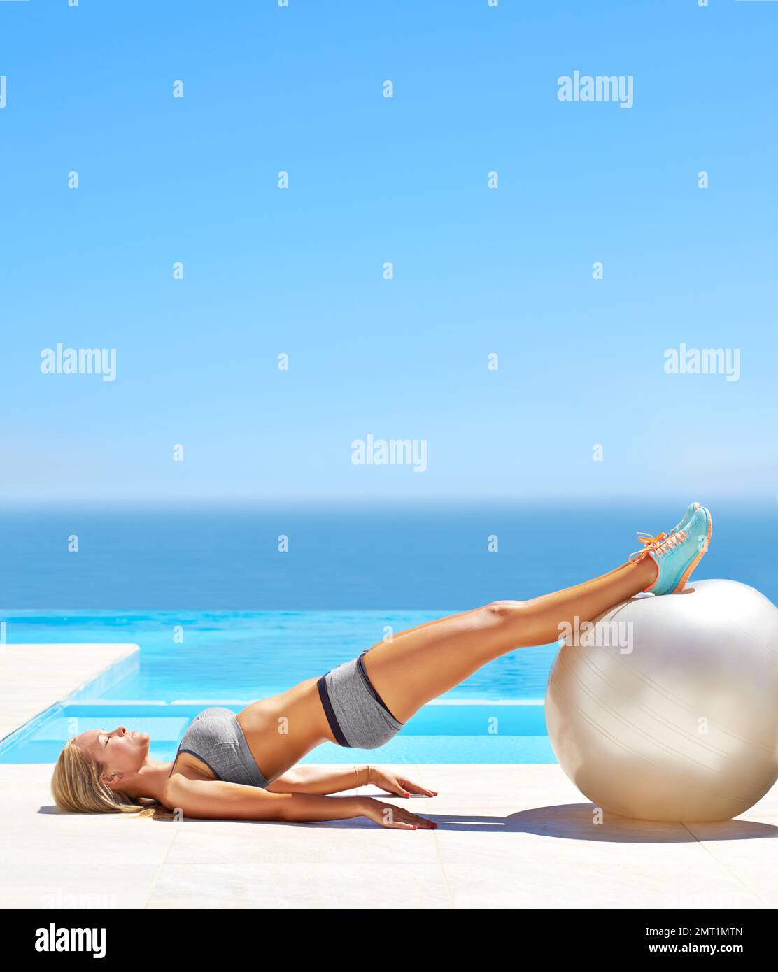 Straight as a board. an attractive young woman working out with an