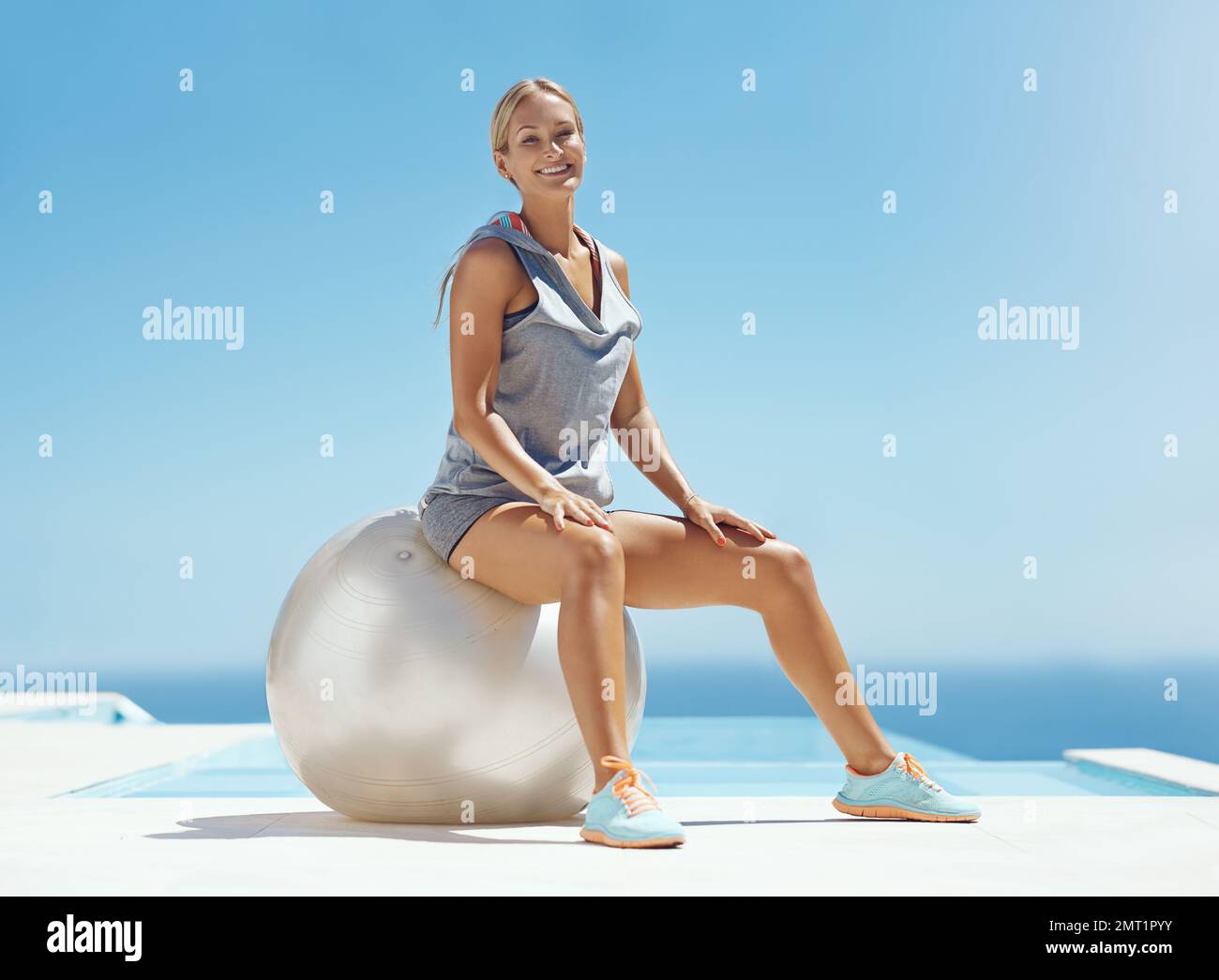 https://c8.alamy.com/comp/2MT1PYY/working-out-makes-me-happy-full-length-portrait-of-an-attractive-young-woman-sitting-on-an-exercise-ball-by-the-pool-after-her-workout-2MT1PYY.jpg