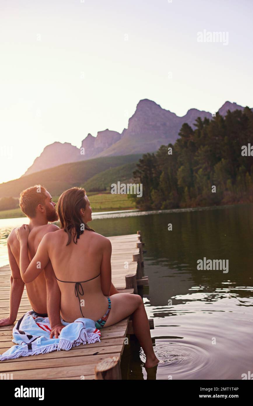 Lakeside harmony. an affectionate young couple at the lake. Stock Photo