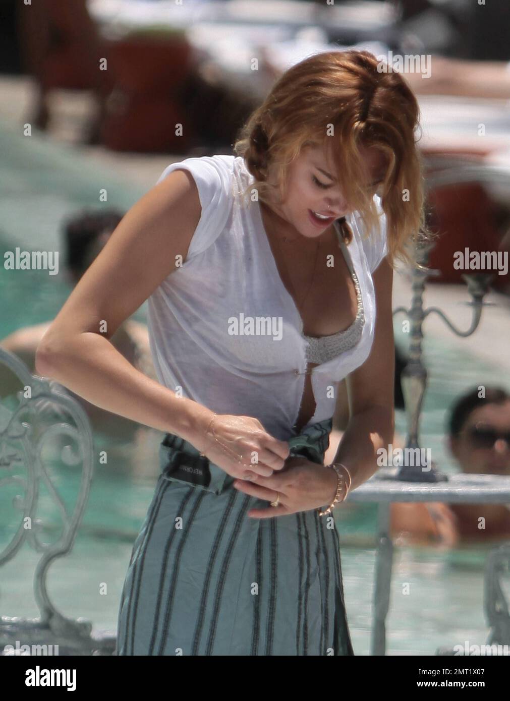 Singer Miley Cyrus spends the day with a friend floating in the pool. Miami  Beach, FL. 13th June 2012 Stock Photo - Alamy