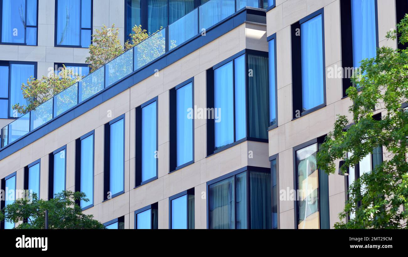 Abstract closeup of the glass-clad facade of a modern building covered ...