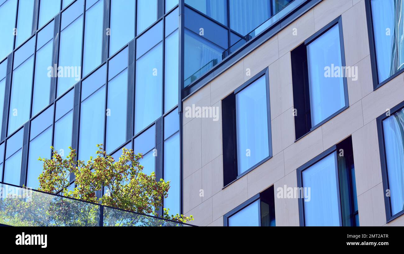 Abstract closeup of the glass-clad facade of a modern building covered ...