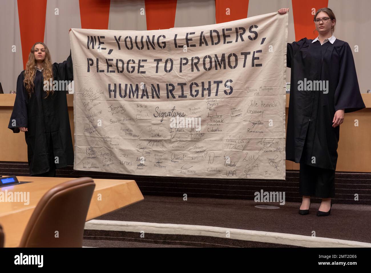 NEW YORK, NEW YORK - JANUARY 31: Students hold pledge banner during a special event 'International Mock Trial on Human Rights' on the occasion of the International Day of Commemoration in Memory of the Victims of the Holocaust (27 Jan) at the New York United Nations Headquarters on January 31, 2023 in New York City.    The participants, student from several countries, interrogate the actions and responsibilities of Ernst Rüdin, the so-called father of Nazi Racial Hygiene. Stock Photo
