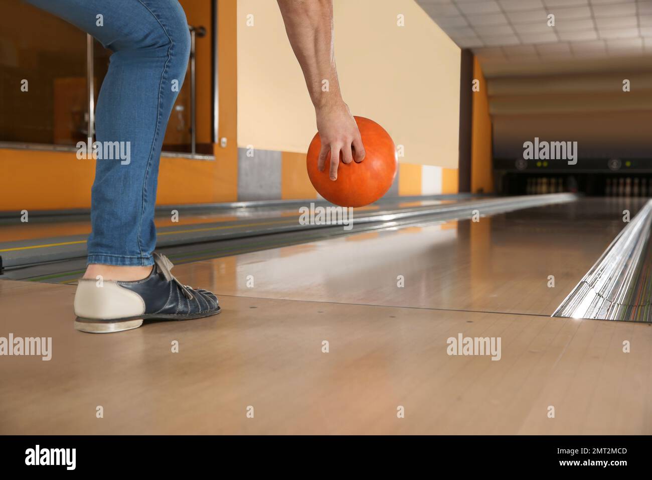 Young man throwing ball in bowling club, closeup Stock Photo Alamy