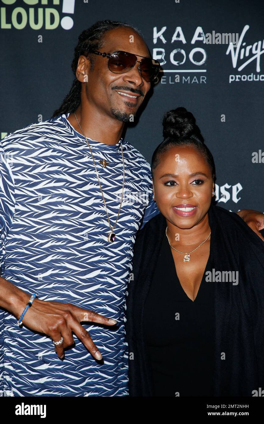 Rapper Snoop Dogg and wife Shante Broadus pose at Kevin Hart&rsquo;s &ldquo;Laugh