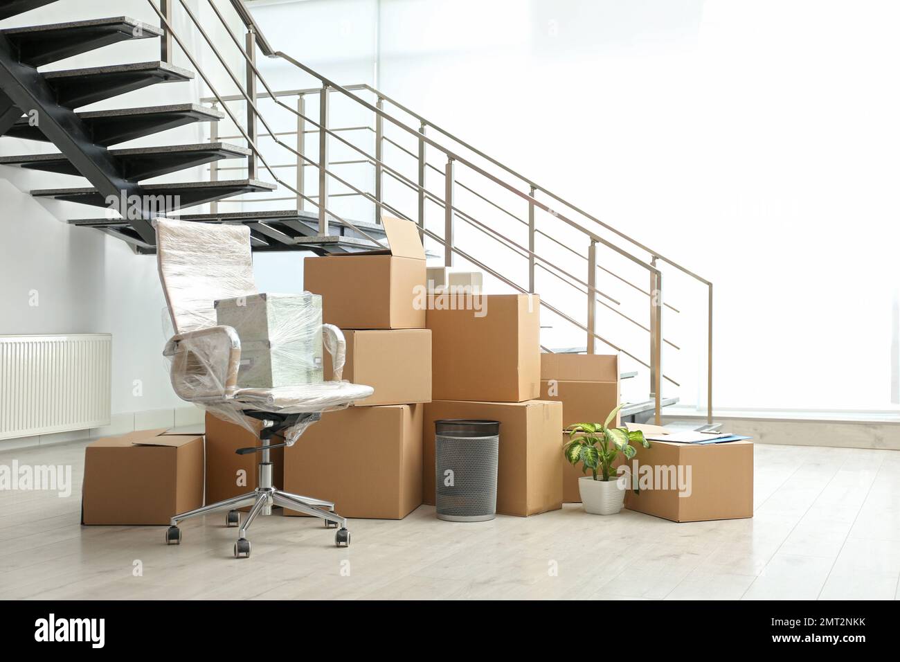 Moving boxes and stuff near stairs in room Stock Photo Alamy