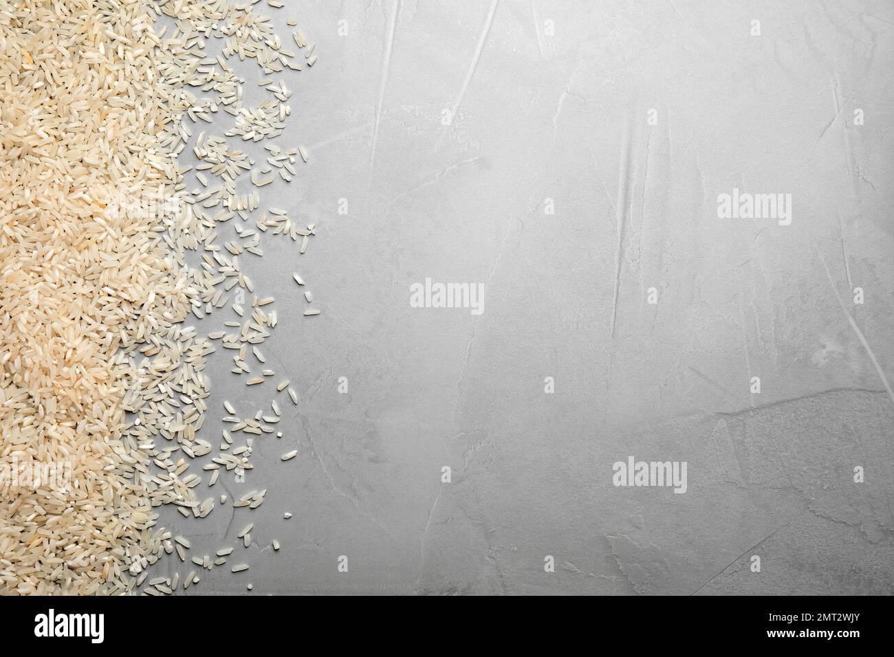 Rice on light grey table, top view. Space for text Stock Photo Alamy