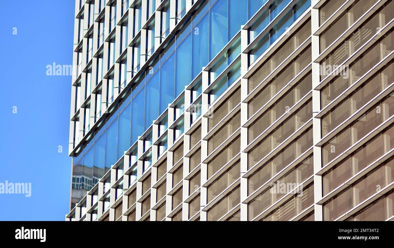 Abstract closeup of the glass-clad facade of a modern building covered ...