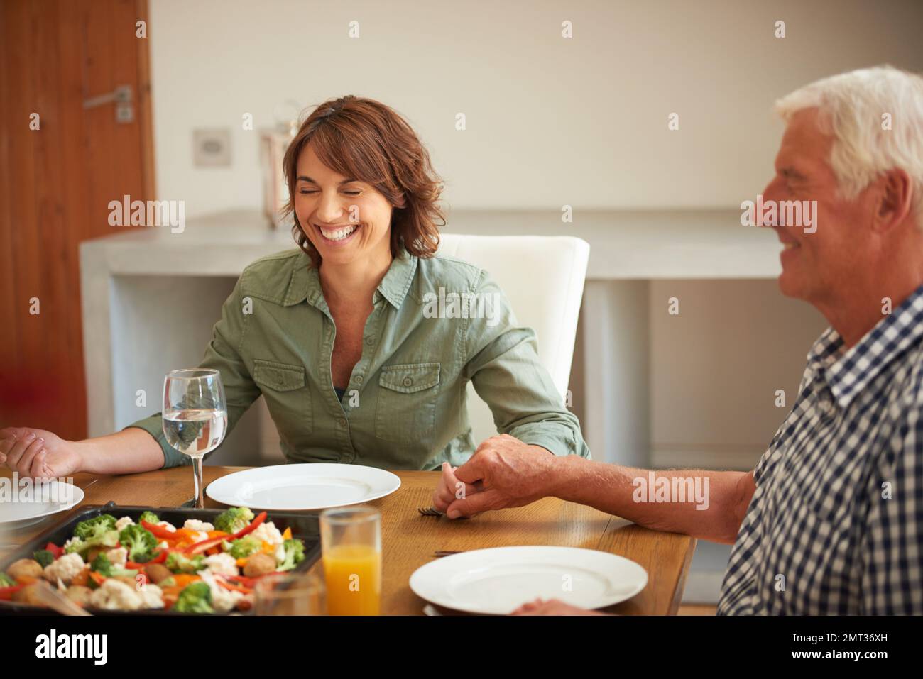 Feeling blessed...a family praying together before having a meal. Stock Photo