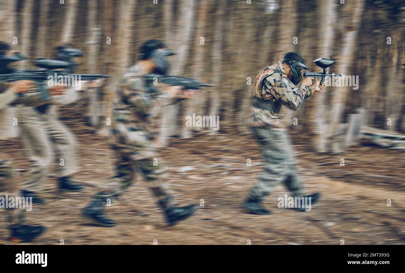 Motion, blur and men running during paintball game, competition and