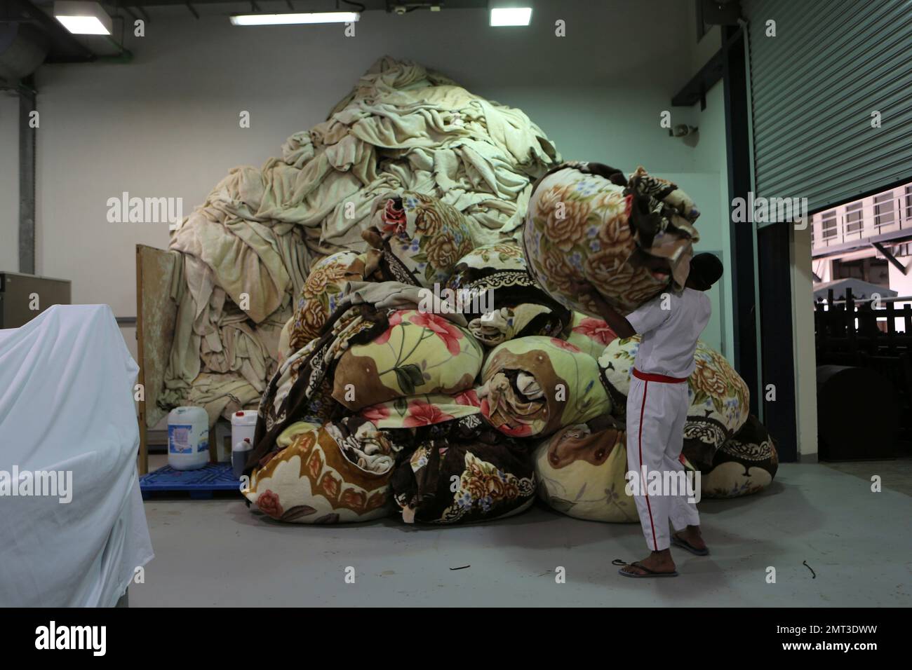 In this Tuesday, July 26, 2017 photo, a prisoner carries a pile of