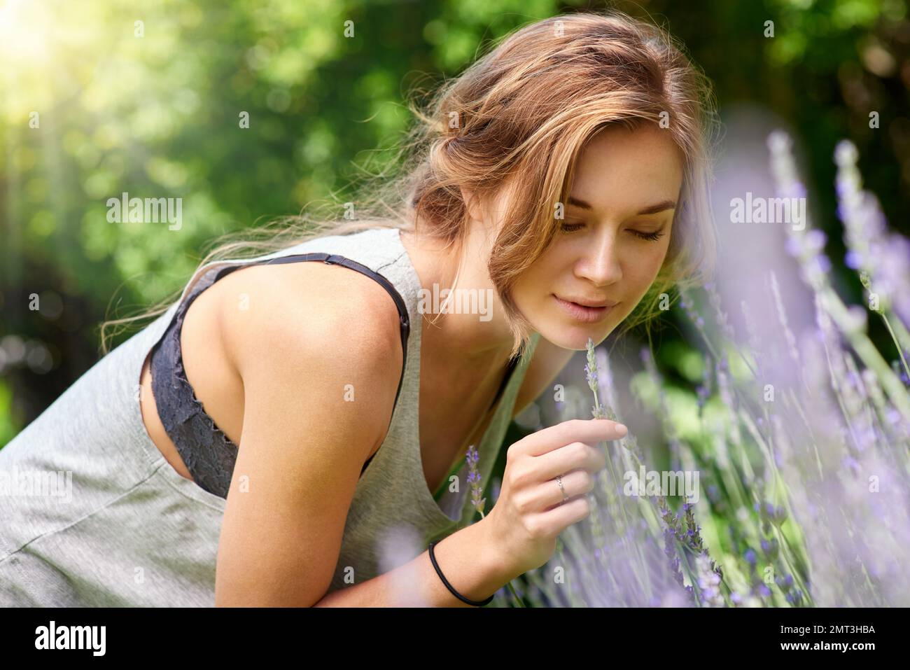 Stop and smell the lavender. A young woman smelling lavender in her