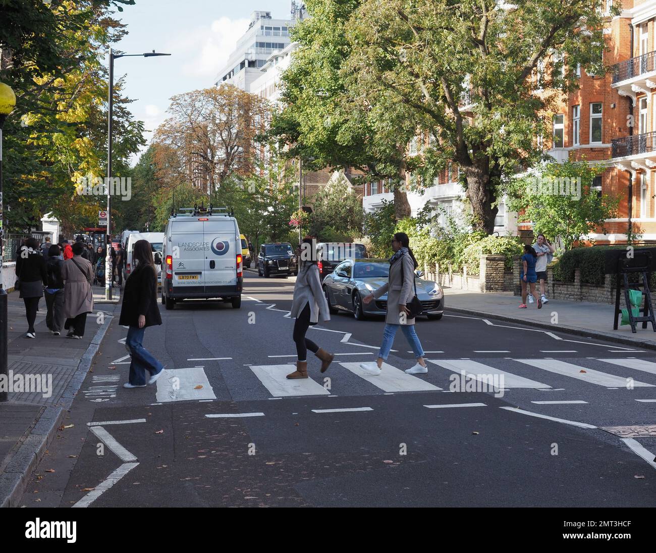 LONDON, UK - CIRCA OCTOBER 2022: People crossing Abbey Road zebra