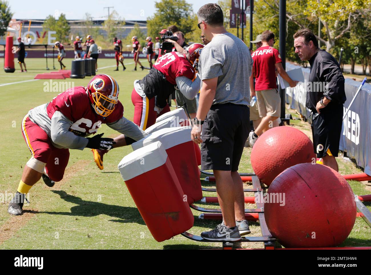 Defensive line coach, Jim Tomsula, right, watches his line as they run