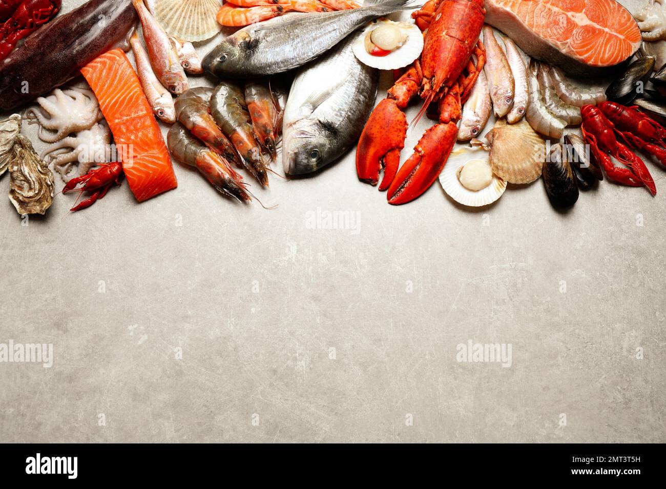 Fresh fish and seafood on marble table, flat lay. Space for text Stock ...