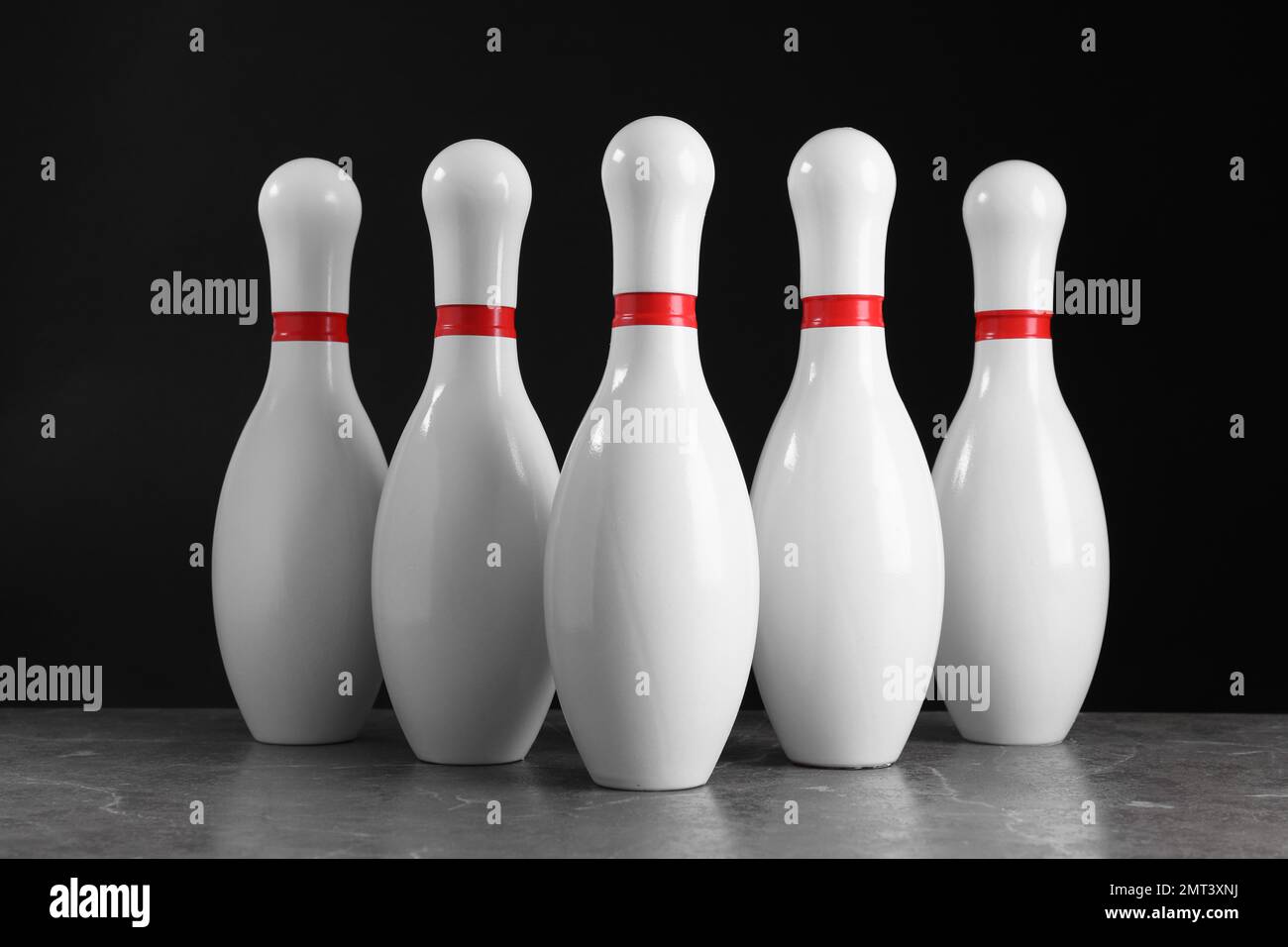 Set of bowling pins on grey stone table Stock Photo Alamy