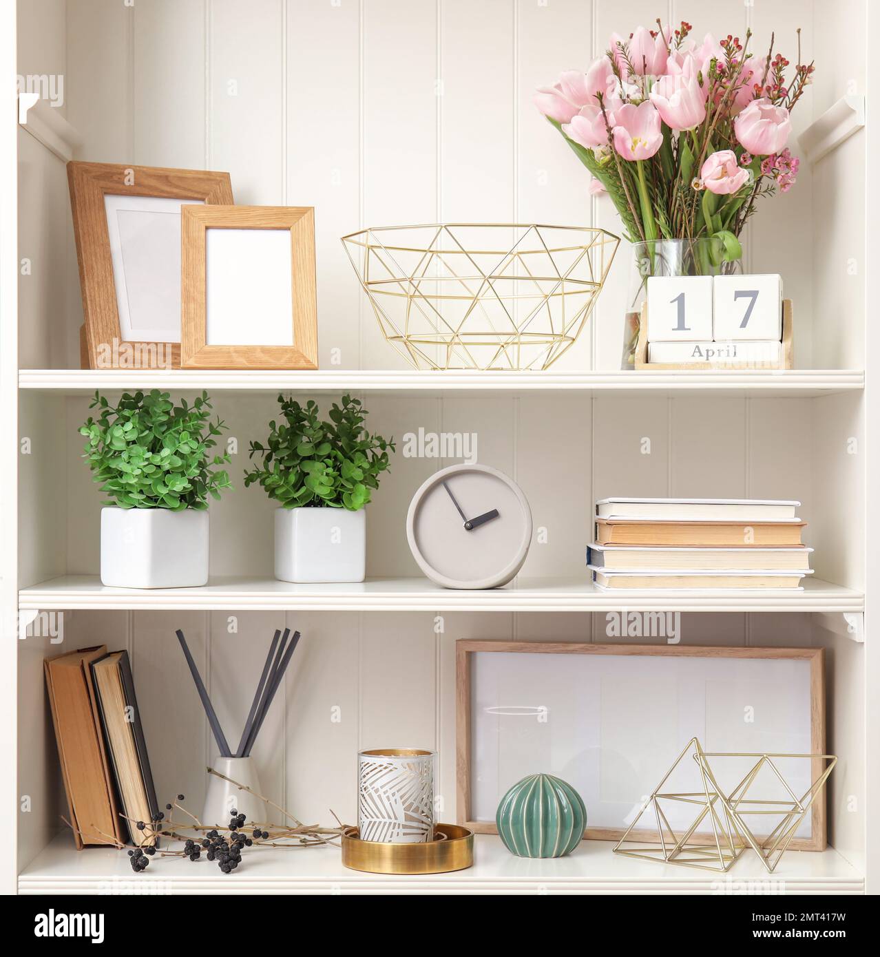 White shelving unit with plants and different decorative stuff Stock Photo