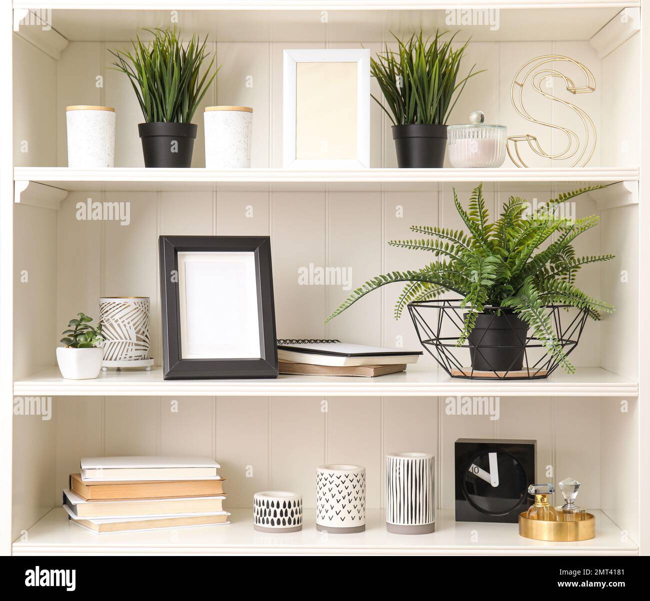 White shelving unit with plants and different decorative stuff Stock