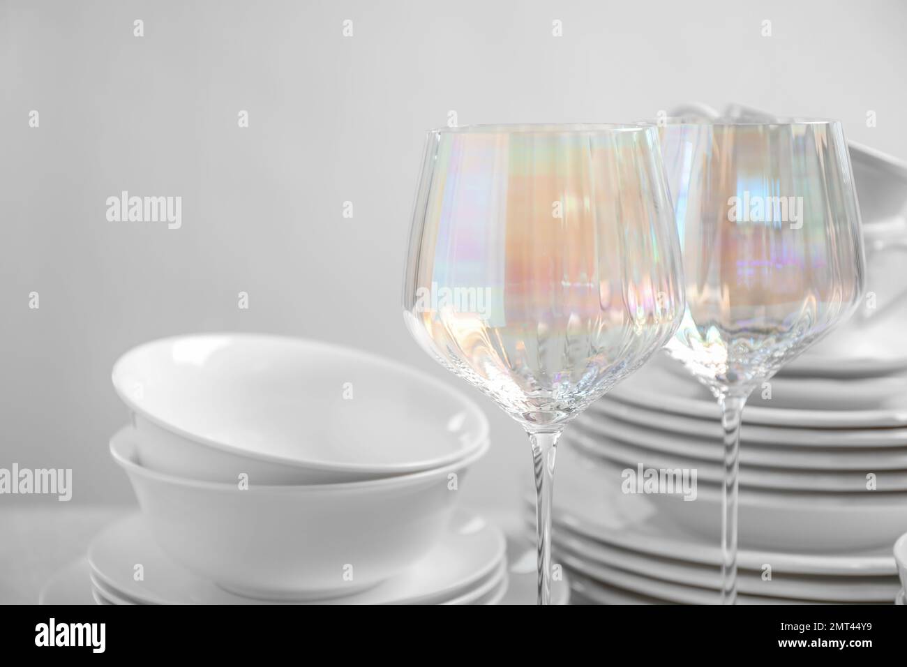 Set of clean dishes and glasses on table Stock Photo Alamy