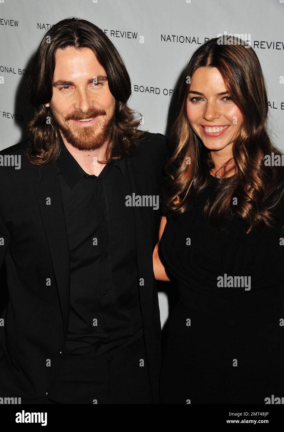 Showing off his growing hair Christian Bale arrives with his wife Sibi  Blazic at the 2011