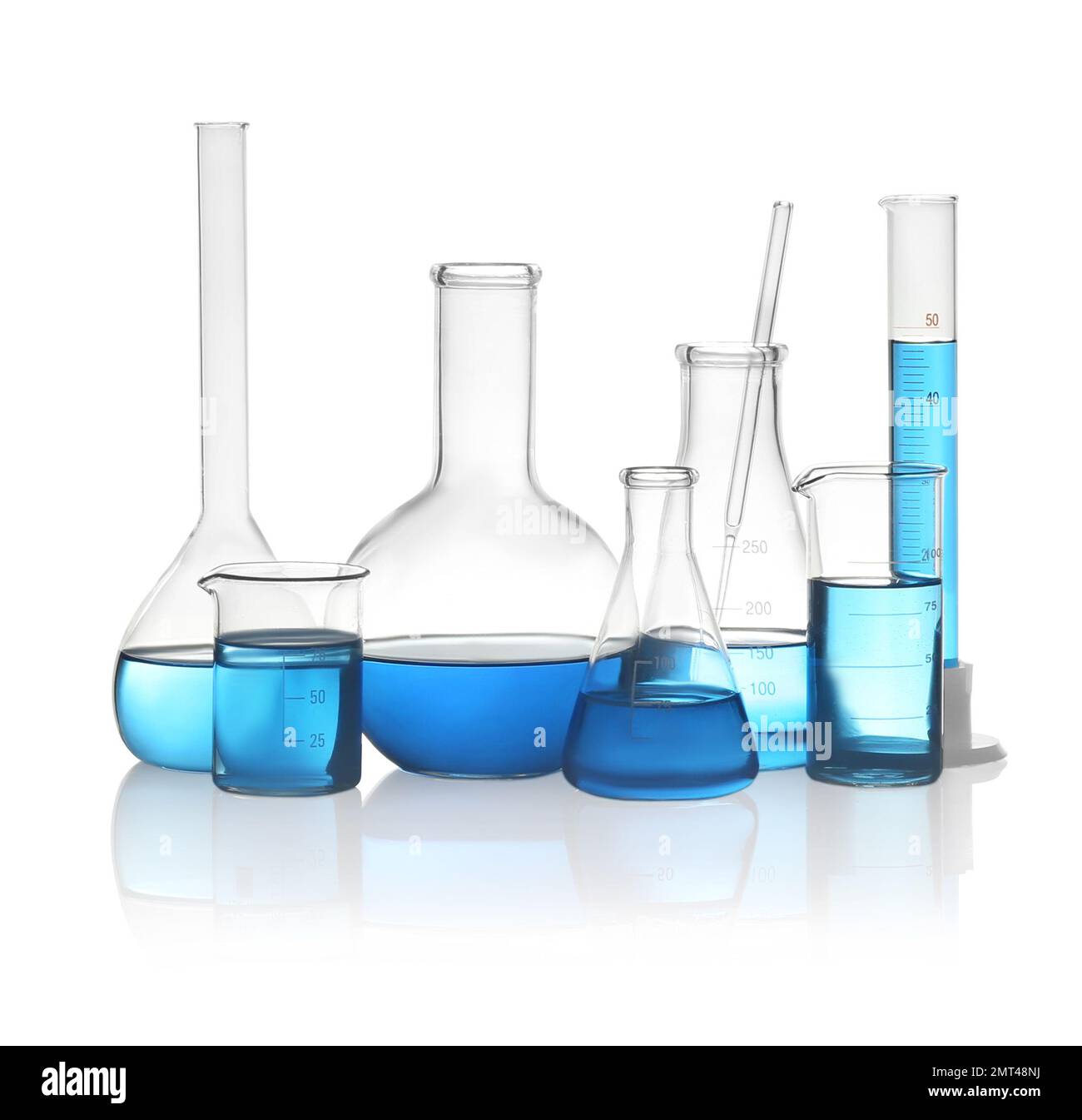Different laboratory glassware with light blue liquid isolated on white