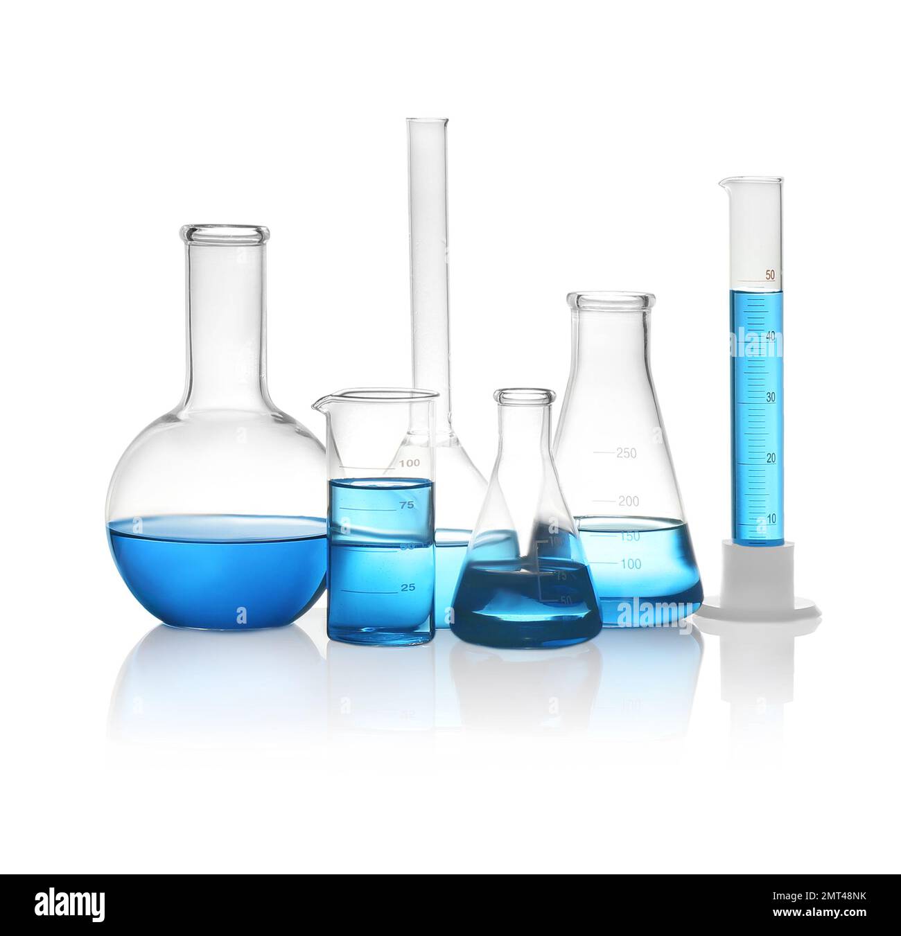 Different laboratory glassware with light blue liquid isolated on white ...
