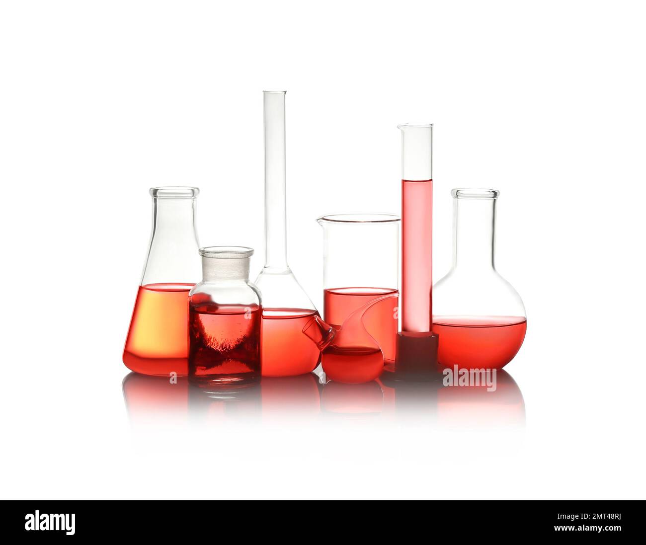 Different laboratory glassware with red liquid isolated on white Stock