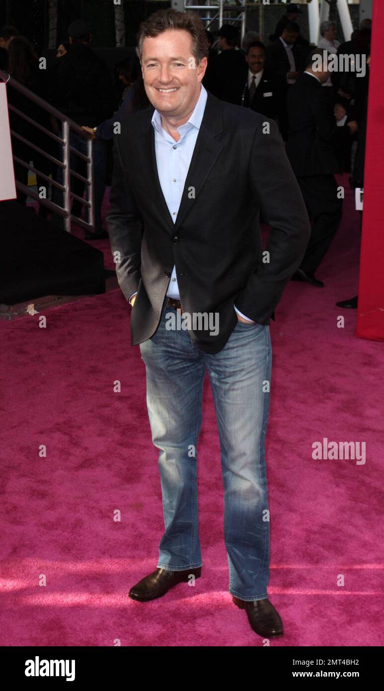 TV personality Piers Morgan poses for photographers on the pink carpet