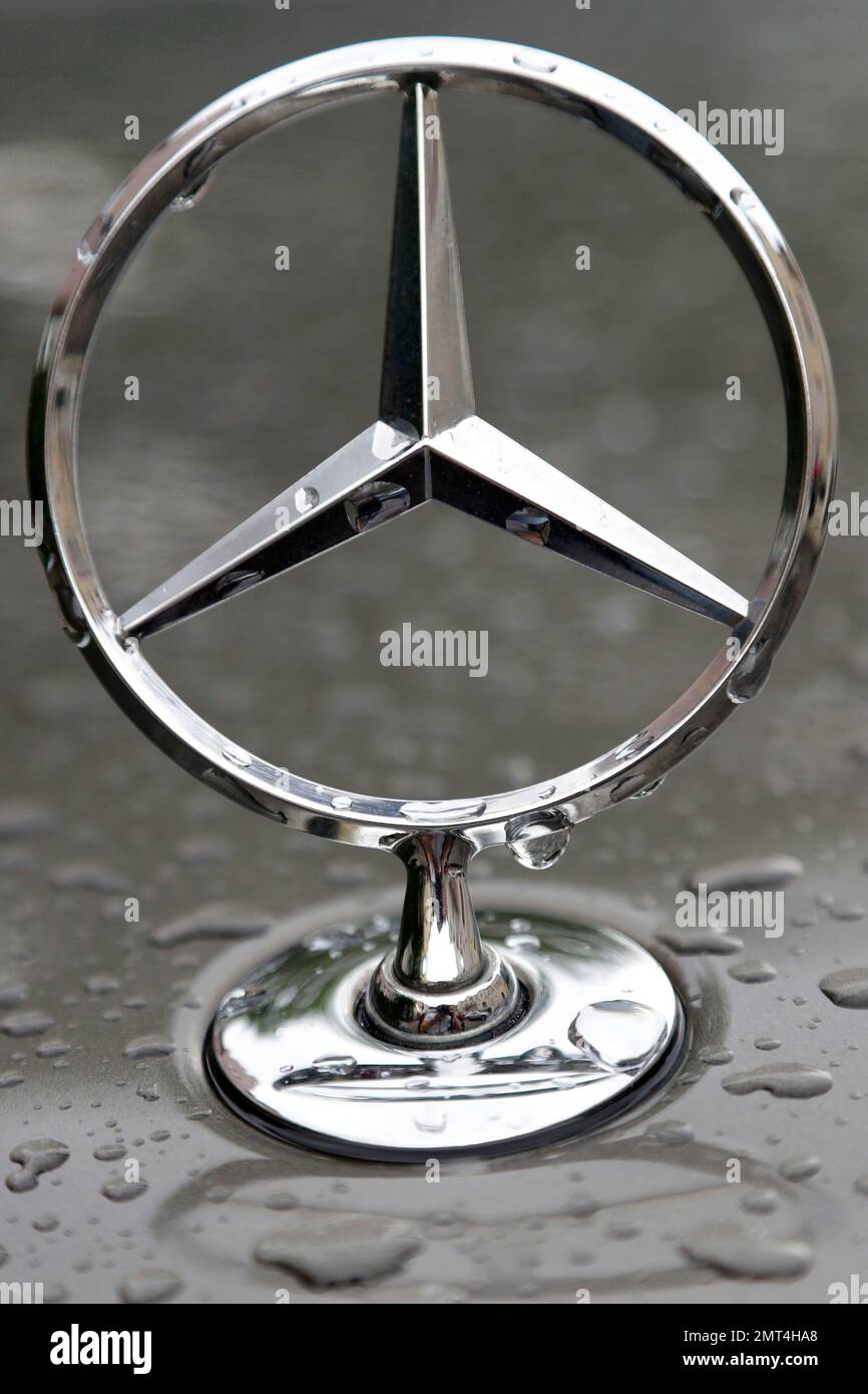 The logo of German car manufacturer MercedesBenz is rain covered at a